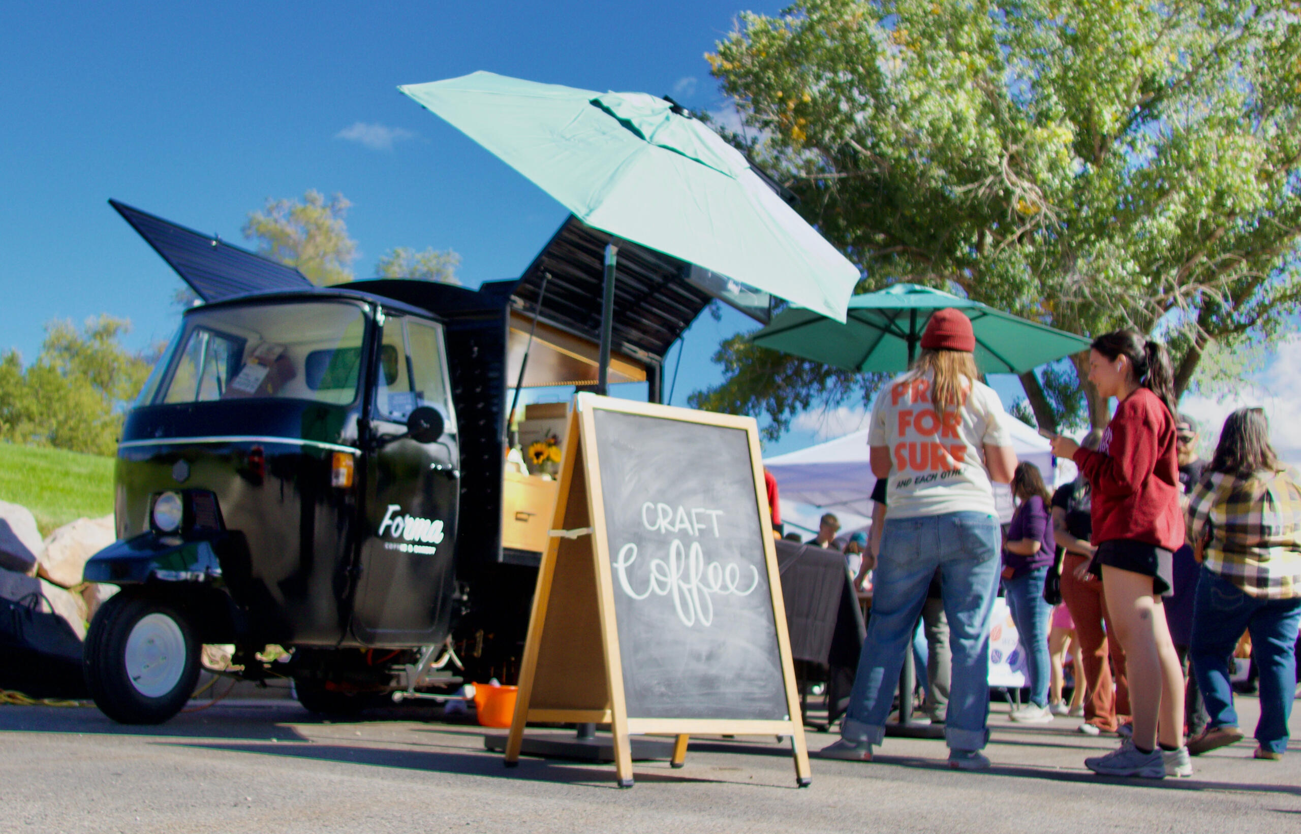 Welcome to Forma Coffee This is a worms eye view of the Forma Coffee cart at a pop up event.